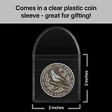 Photo of a round sobriety coin with cardinal design in a clear plastic sleeve with size dimensions marked as 2 inches wide by 2 inches tall