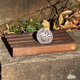Photo of Starry Night sobriety coin displayed on wooden stand with circular design and text visible on silver coin